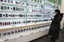 A customer looks at a display of handsets for sale inside a MegaFon shop in St. Petersburg