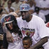 The Miami Heat's LeBron James embraces his fiancé Savannah Brinson and his children LeBron James Jr., 7 and Bryce Maximus James 5 after Game 5 of the NBA finals basketball series against the Oklahoma City Thunder, Thursday, June 21, 2012, in Miami. The Heat won 121-106 to become the 2012 NBA Champions. (AP Photo/Lynne Sladky)