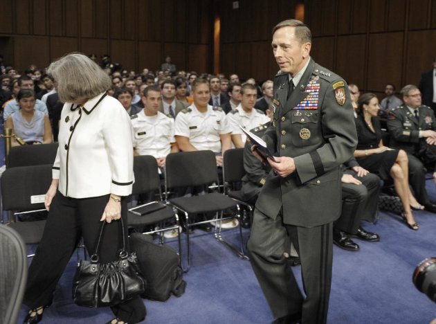 FILE - In this June 23, 2011, file photo, Gen. David Petraeus, center, walks with his wife Holly, left, past a seated Paula Broadwell, rear right, as he arrives to appear before the Senate Intelligence Committee during a hearing on his nomination to be Director of the Central Intelligence Agency on Capitol Hill in Washington. Petraeus quit Nov. 9, 2012, after acknowledging an extramarital relationship. As questions arise about the extramarital affair between Petraeus and his biographer, Paula Broadwell, she has remained quiet about details of their relationship. However, information has emerged about Jill Kelley, the woman who received the emails from Broadwell that led to the FBI’s discovery of Petraeus’ indiscretion. (AP Photo/Cliff Owen, File)