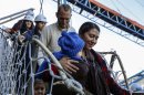 Hannah Gastonguay, holding her baby Rahab, is followed by her husband Sean and the couple's 3-year-old daughter Ardith, as they disembark in the port city of San Antonio, Chile, Friday, Aug. 9, 2013. The northern Arizona family was lost at sea for weeks in an ill-fated attempt to leave the U.S. over what they consider government interference in religion. But just weeks into their journey the Gastonguays hit a series of storms that damaged their small boat, leaving them adrift for weeks. They were eventually picked up by a Venezuelan fishing vessel, transferred to a Japanese cargo ship and taken to Chile where they are resting in a hotel in San Antonio. (AP Photo/Las Ultimas Noticias)
