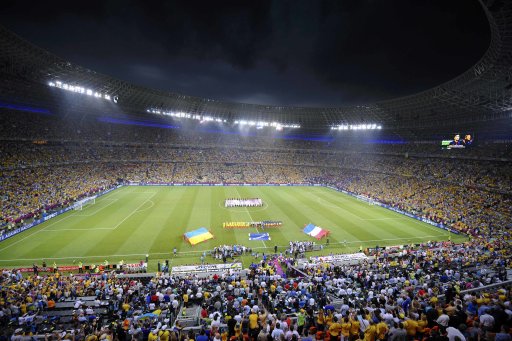 A general view of Donbass Arena shows members of Ukraine's and France's national teams pose before their Group D Euro 2012 soccer match in Donetsk