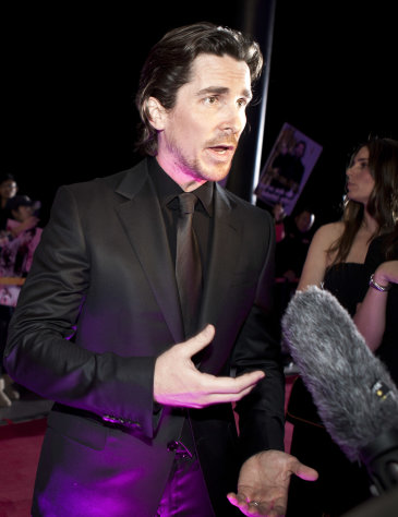 In this photo taken on Monday, Dec. 12, 2011, English actor Christian Bale speaks to journalists during an interview on the red carpet as he arrives for an event of the Zhang Yimou-directed new movie "The Flowers of War" in Beijing, China. Academy Award winner Christian Bale, in the midst of promoting a film he made in China some critics have called propaganda, got stopped trying to visit a blind activist living under house arrest, with a CNN camera crew in tow. CNN posted footage of a scuffle between Bale and the activist's guards on its website Friday, Dec. 16. (AP Photo/Andy Wong)