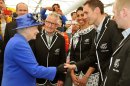 Queen Elizabeth II meets athlete Nick Willis and other members of the New Zealand Olympic team, as she tours the Athletes Village dining hall at the Olympic Park, in London, Saturday July 28, 2012. (AP Photo/John Stillwell, Pool)