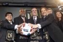 Celebrating the introduction of the new Los Angeles Football Club's logo and colors are, from left, managing partner Henry Nguyen, L.A. City Councilman Curren Price, Mayor Eric Garcetti, Peter Guber, and Mia Hamm Garciaparra, during the new soccer club's news conference in Los Angeles Thursday, Jan. 7, 2016. (AP Photo/Nick Ut)