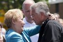 Raymond Lafontaine, who lost his son and two daughters-in-law, receives a hug from Quebec Premier Pauline Marois during her visit to Lac-Megantic, Quebec, Thursday, July 11, 2013. Marois toured the site of Canada's worst railway catastrophe in almost 150 years, after a runaway oil train killed 50 people in a fiery explosion. (AP Photo/The Canadian Press, Ryan Remiorz)