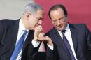 French President Francois Hollande (R) listens to Israel's Prime minister Benjamin Netanyahu during his welcome ceremony at Jerusalem's Ben Gourion airport for a tree-days state visit on November 17, 2013