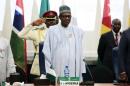 Nigeria's President Muhammadu Buhari stands at the opening of the 48th ordinary session of ECOWAS Authority of Head of States and Government in Abuja
