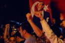 Thousands of Turkish protesters, holding national flags and portraits of Turkey's founder Mustafa Kemal Ataturk, jubilate as they march in Turkish capital, Ankara, Thursday, June 6, 2013. Turkish Prime Minister Recep Tayyip Erdogan on Thursday appeared to have slightly moderated his rhetoric regarding the anti-government protests in his country but didn't back away from redevelopment plans for Istanbul that sparked the nearly week-long unrest and claimed 