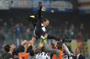 Juventus' coach Massimiliano Allegri is thrown in the air in celebration at the end of a Serie A soccer match between Sampdoria and Juventus, at the Luigi Ferraris stadium in Genoa, Italy, Saturday, May 2, 2015. Juventus clinched a fourth successive Serie A title with a 1-0 win at Sampdoria on Saturday but put its trophy celebrations on ice with a crucial Champions League match in just three days. (AP Photo/Carlo Baroncini)