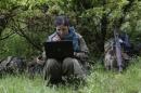 A member of Kurdistan Workers Party (PKK) works on her laptop in northern Iraq