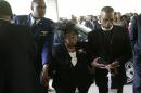 Judy Scott, center, is escorted in for the funeral of her son, Walter Scott, at W.O.R.D. Ministries Christian Center, Saturday, April 11, 2015, in Summerville, S.C. Scott was killed by a North Charleston police officer after a traffic Saturday, April 4, 2015. The officer, Michael Thomas Slager, has been charged with murder. (AP Photo/David Goldman, Pool)