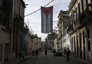 A Cuban flag hangs from a building in Havana