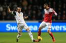Fulham's Dimitar Berbatov, right, and Swansea City's Chico battle for the ball during their English Premier League soccer match at the Liberty Stadium, Swansea, Wales, Tuesday, Jan. 28, 2014. (AP Photo/Nick Potts, PA Wire) UNITED KINGDOM OUT - NO SALES - NO ARCHIVES