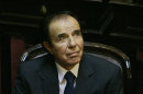 FILE - In this Nov. 29, 2005 file photo, Former Argentine President Carlos Menem attends his swearing-in ceremony as senator for La Rioja province at the National Congress in Buenos Aires, Argentina. Menem was sentenced Thursday, June 13, 2013, to 7 years in prison for smuggling weapons to Ecuador and Croatia in violation of international embargoes in the 1990s. The court also banned Menem from holding elective office, and asked the Senate to vote to remove the immunity he has enjoyed for years as senator. (AP Photo/Natacha Pisarenko, File)