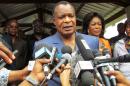 Congolese President Denis Sassou Nguessou talks to the media after voting on October 25, 2015 in Brazzaville