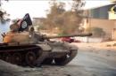 An image grab from a video made available on October 9, 2014, by al-Raya Media Foundation allegedly shows a tank belonging to the Ansar al-Sharia militant group, flying the Jihadist flag, during a battle in the Libyan city of Benghazi