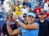 Li of China holds up the championship trophy after defeating Kerber of Germany at the women's Cincinnati Open tennis tournament in Cincinnati