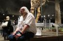 In a Saturday, May 21, 2016 photo, Jack Horner smiles as he sits under Montana's T Rex in the Museum of the Rockies in Bozeman, Mont. The museum hosted "Jack Horner Family Day" ahead of Horner's retirement this summer after leading the museum for 34 years and establishing himself as one of the most famous paleontologists in the world. (AP Photo/Matt Volz)