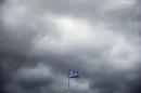 A Greek national flag flutters atop Athens University