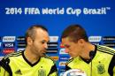 Spain's Andres Iniesta, left, and Fernando Torres talk during an official training session the day before the group B World Cup soccer match between Spain and Chile at the Maracana stadium in Rio de Janeiro, Brazil, Tuesday, June 17, 2014. Spain will play in group B of the Brazil 2014 World Cup. (AP Photo/Manu Fernandez)