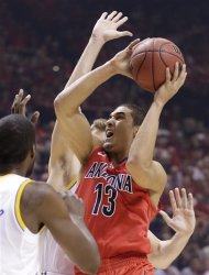 Arizona's Nick Johnson (13) goes up for a shot against UCLA in the first half during a semifinal Pac-12 tournament NCAA college basketball game, Friday, March 15, 2013, in Las Vegas. (AP Photo/Julie Jacobson)