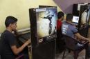 Iraqi Shi'ite youths use computers at an internet cafe in Sadr City in Baghdad