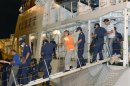 Chinese activists arrested on suspicion of violating Immigration Control and Refugee Recognition Law at disputed island in East China Sea, known as Senkaku in Japan or Diaoyu in China, escorted by Japan Coast Guard crew as they disembark in Naha