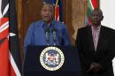 Kenyan President Uhuru Kenyatta, flanked by his Deputy William Ruto, addresses a news conference at the State House in Nairobi