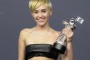 Singer Miley Cyrus poses backstage after winning Video of the Year for "Wrecking Ball" during the 2014 MTV Video Music Awards in Inglewood