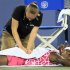 Venus Williams has her back worked on by a trainer during a semifinals match against Li Na, from China, at the Western & Southern Open tennis tournament, Saturday, Aug. 18, 2012, in Mason, Ohio. (AP Photo/Al Behrman)