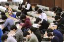 In this January 2013 photo, preparatory students sit for National Center Test for University Admissions at the University of Tokyo. Students from Shanghai, Hong Kong, Singapore, Taiwan, Japan and South Korea were among the highest-ranking groups in math, science and reading in test results released Tuesday, Dec. 3, 2013 by the Program for International Student Assessment (PISA) coordinated by the Paris-based Organization for Economic Cooperation and Development (OECD). The group tests students worldwide every three years. In Japan, the government added 1,200 pages to elementary school textbooks after its children fell behind in those in rivals such as South Korea and Hong Kong in 2009, although Japan's scores for 2009 were tops for rich industrialized countries. Japan has since improved its standings in all three areas. (AP Photo/Kyodo News) JAPAN OUT, CREDIT MANDATORY