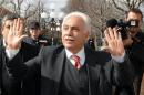 Turkish politician Perincek waves to supporters outside the court in Lausanne