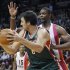 The Miami Heats' Bosh defends against Milwaukee Bucks' Bogut during their NBA basketball game in Miami