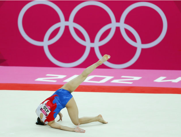 Moldir Azimbay of Kazakhstan falls during her floor exercise during the women&#39;s gymnastics qualification at the London 2012 Olympic Games