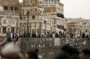 People gather to look at the site of a car bomb attack outside the Qubbat al-Mahdi mosque in Yemen's capital Sanaa
