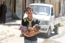 A civilian evacuates a baby from a site hit by airstrikes in the rebel held area of Aleppo's al-Fardous district