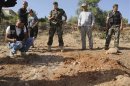 Lebanese soldiers inspect site which was hit by rocket, which residents say was recently fired from Syria overnight, in Seriine