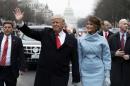Donald Trump and first lady Melania Trump walk during the inaugural parade from the U.S. Capitol in Washington