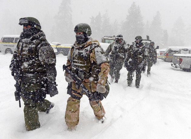 A San Bernardino County Sheriff SWAT team returns to the command post at Bear Mountain near Big Bear Lake, Calif. after searching for Christopher Jordan Dorner on Friday, Feb. 8, 2013. Search conditions have been hampered by a heavy winter storm in the area. Dorner, a former Los Angeles police officer, is accused of carrying out a killing spree because he felt he was unfairly fired from his job. (AP Photo/The Inland Valley Daily Bulletin, Will Lester, Pool)