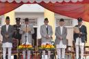 Nepal's President Ram Baran Yadav, second left, administers the oath of office to newly elected Prime Minister Khadga Prasad Oli, right, at the Presidential building in Kathmandu, Nepal, Monday, Oct. 12, 2015. Nepal's new prime minister took the oath of office Monday and appointed the leaders of groups that are protesting the new constitution as his deputies. (AP Photo/Niranjan Shrestha)