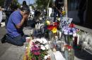 Jose Cardoso cries in front of a makeshift memorial for UCSB student Christopher Michael-Martinez in Isla Vista