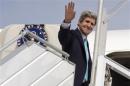 U.S. Secretary of State John Kerry waves before his flight leaving Paris