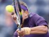 Victoria Azarenka of Belarus returns a shot against Daniela Hantuchova of Slovakia during their match at the BNP Paribas Open WTA tennis tournament in Indian Wells, California