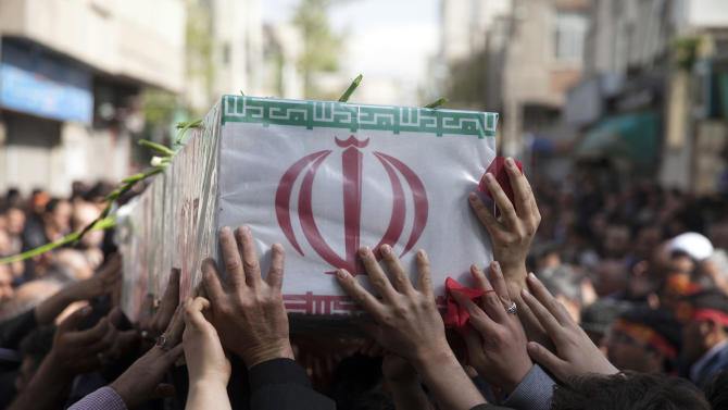 In this picture taken on Sunday, March 29, 2015, and released by the semi official Iranian Fars News Agency, a group of mourners carry the flag draped coffin of Ali Yazdani, a member of Iran's Revolutionary Guard, whom the Guard says has been killed during U.S. drone strike near the Iraqi city of Tikrit. Iran's Revolutionary Guard says a U.S. drone strike killed two of its advisers near the Iraqi city of Tikrit, though the U.S. said Monday its coalition conducted no airstrikes against the Islamic State group in the area during that time. (AP Photo/Fars News Agency, Mohammad Reza Jofar)