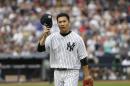 New York Yankees starting pitcher Masahiro Tanaka tips his cap as he leaves the game during the sixth inning of the baseball game against the Toronto Blue Jays at Yankee Stadium, Sunday, Sept. 21, 2014 in New York. (AP Photo/Seth Wenig)