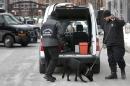 Boston Police Special Operations officers use a bomb-sniffing dog while searching a vehicle on a street near the federal courthouse, in Boston, Tuesday, March 3, 2015. A panel of 12 jurors and six alternates was seated Tuesday after two months of jury selection for the federal death penalty trial of Boston Marathon bombing suspect Dzhokhar Tsarnaev. (AP Photo/Steven Senne)