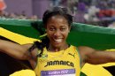 Jamaica's Shelly-Ann Fraser-Pryce celebrates winning gold in the women's 100-meter final during the athletics competition in the Olympic Stadium at the 2012 Summer Olympics, Saturday, Aug. 4, 2012, in London.(AP Photo/David J. Phillip)
