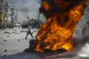 Protesters burn tires during a march against the government of Haitian President Michel Martelly in Port-au-Prince, on January 11, 2015