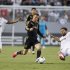 Los Angeles Galaxy's David Beckham (C) chases the ball between Real Madrid's Fabio Coentrao (L) and Xabi Alonso (R) during the first half of their World Football Challenge international friendly soccer match in Carson, California August 2, 2012.
