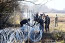 Slovenian soldiers set barbed wire fences on the Slovenian-Croatian border near Rakovec on November 12, 2015